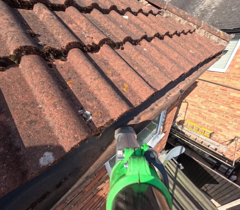 Gutter cleared of leaves and moss after cleaning, concrete tile roof, GoPro footage