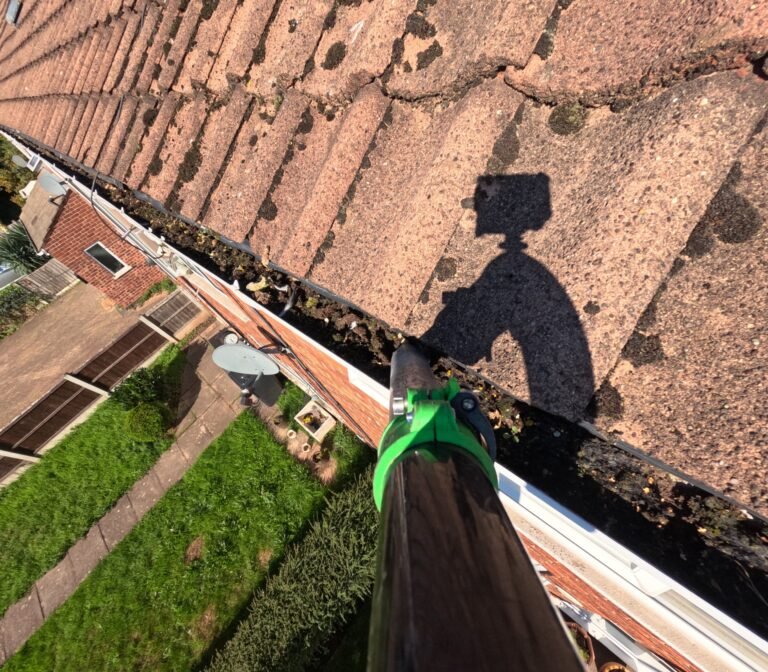 Gutter packed with moss before cleaning, concrete tile roof, GoPro footage